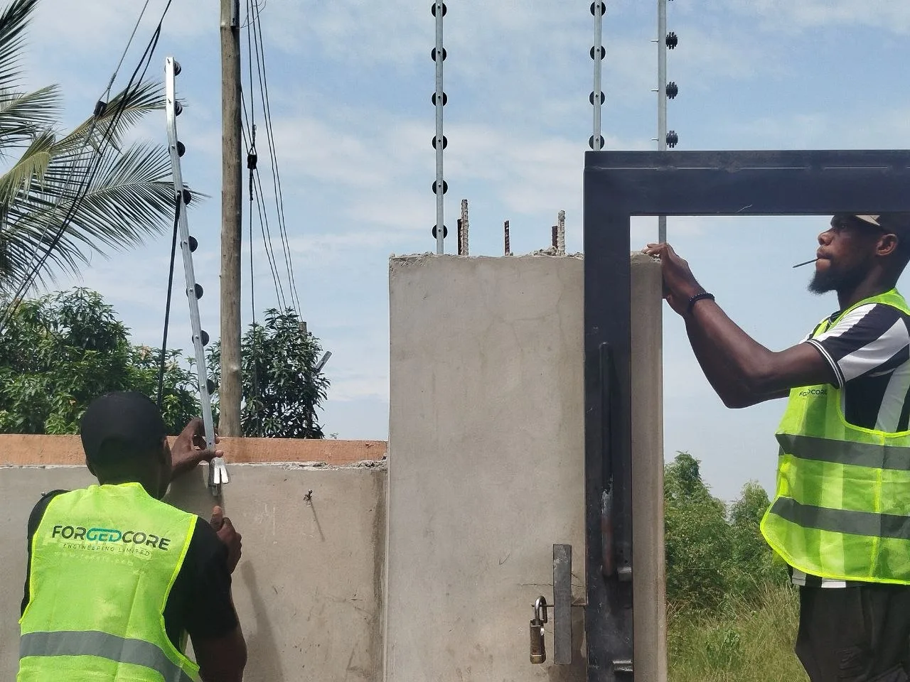 Team installing electric fence posts and gate security