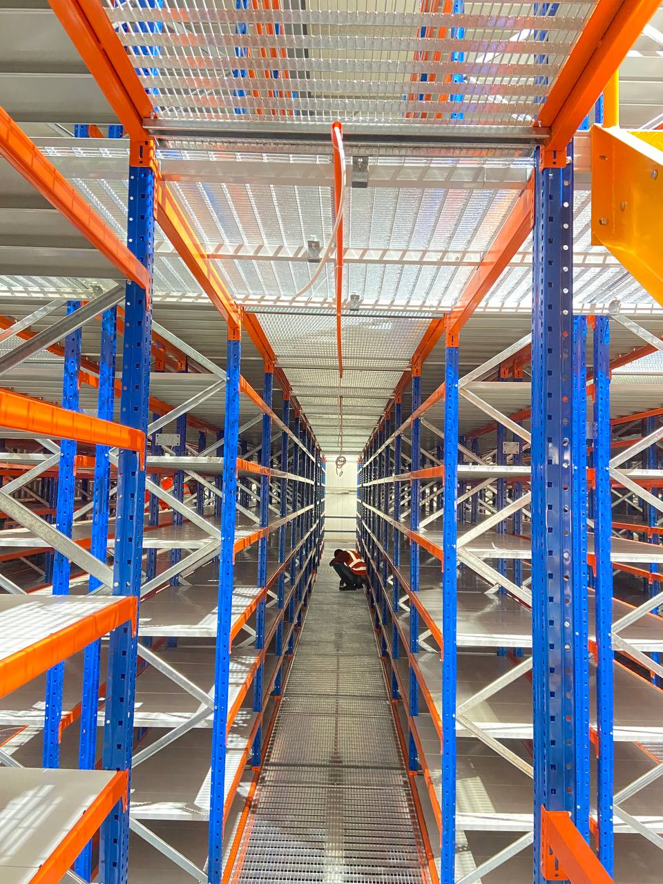 Warehouse aisle lighting with storage racks